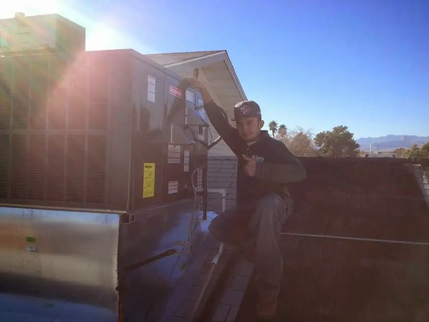 HVAC technician performing HVAC Inspection on a rooftop unit in Medulla